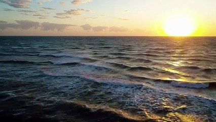 foamy waves of the sea crashing with a coastline