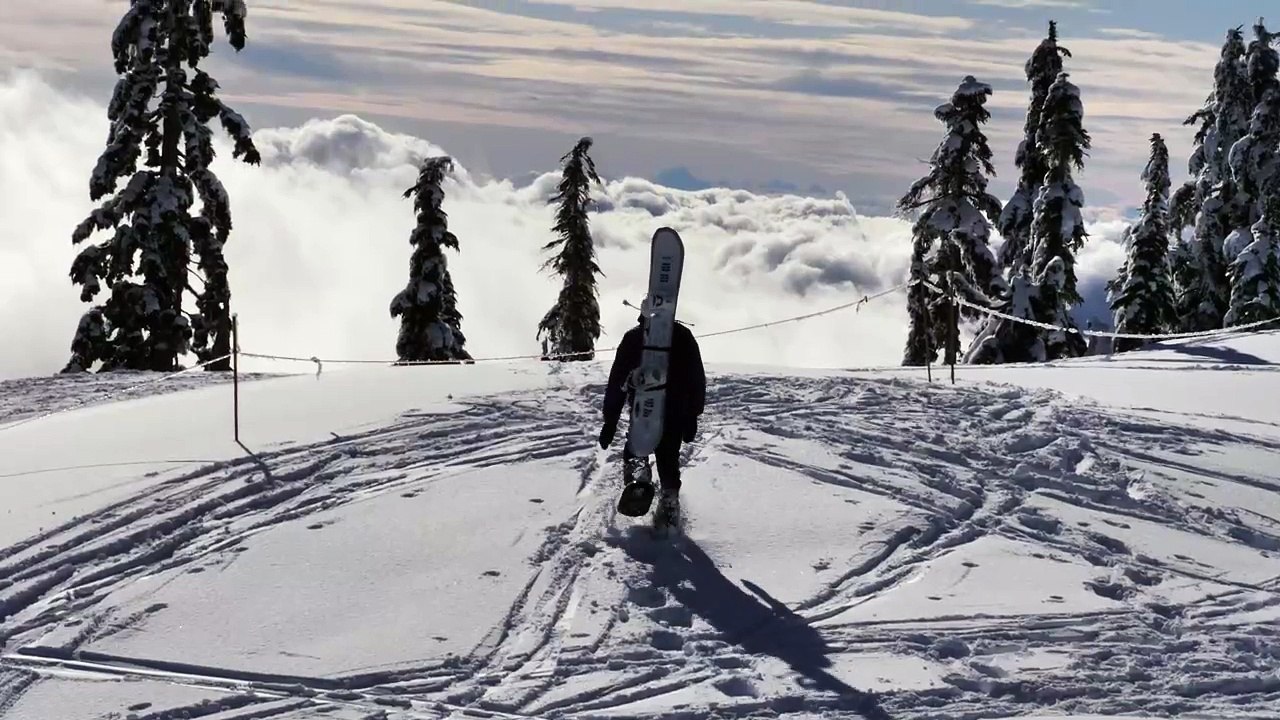 Skier at the peak of a snowy mountain
