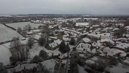 Snow and ice covers UK towns as cold blast continues to disrupt travel