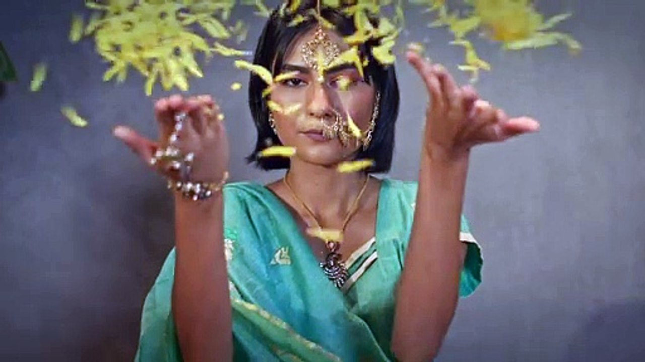 young woman in indian traditional attire and wearing face jewelry