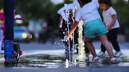 children playing with a dancing fountain