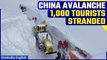 China: Many tourists stranded in Xinjiang after dozens of avalanches block highways | Oneindia News