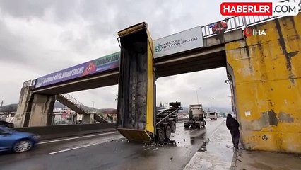 Tırın açılan damperi üst geçitte asılı kaldı