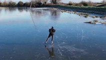 Ice skaters glide over frozen Cambridgeshire Fens