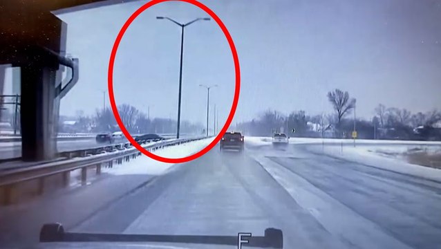 Watch moment pole crashes onto motorway inches away from police officer