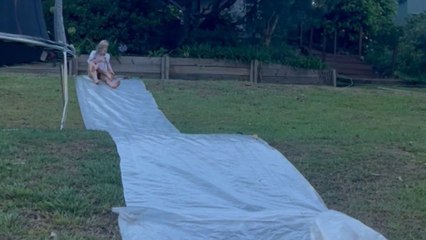 Australian Christmas chaos: Slip-and-slide dream meets unexpected paws