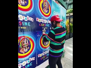 Watch: 6ix9ine is so upset at having low album sales, that he's ripping down his own poster