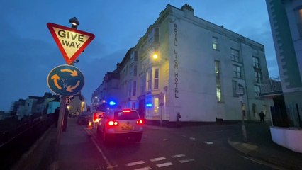 Tenby High Street closed off with firefighters at the scene of a property