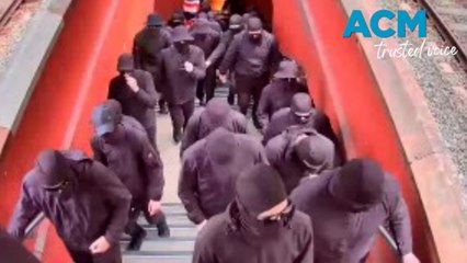 Balaclava-wearing group storm Sydney train station