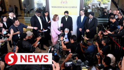 Daim attempts to read statement to press after court proceedings