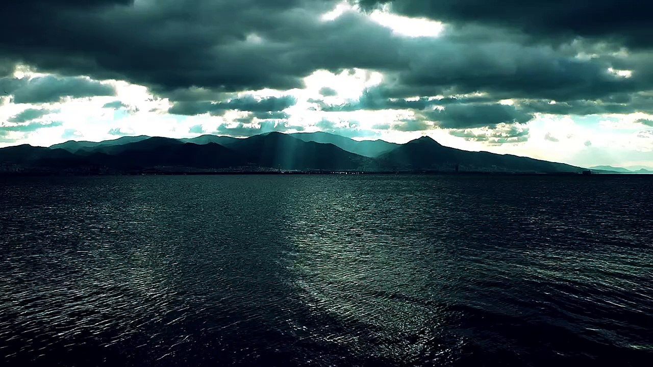 Dark landscape of a calm sea and a cloudy sky