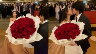 Adorable moment young man surprises prom date with a giant bouquet of flowers