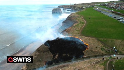Drone footage shows a grass fire dramatically spreading along cliffs in Tyne and Wear