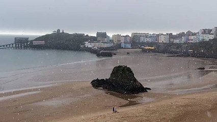 Rare sight of snow falling on Tenby beach