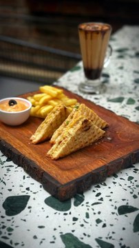 Discover the ultimate trio: golden fries, delectable sandwiches, and the warmth of hot chocolate. Join us at our cafe, where every bite and sip is a symphony of flavours waiting to be savoured.