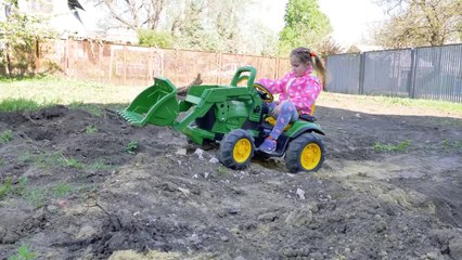 Melissa is riding a Toy Tractor and helping tidy up around the house