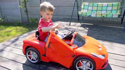 Arthur is playing at the car wash and washing his Ferrari