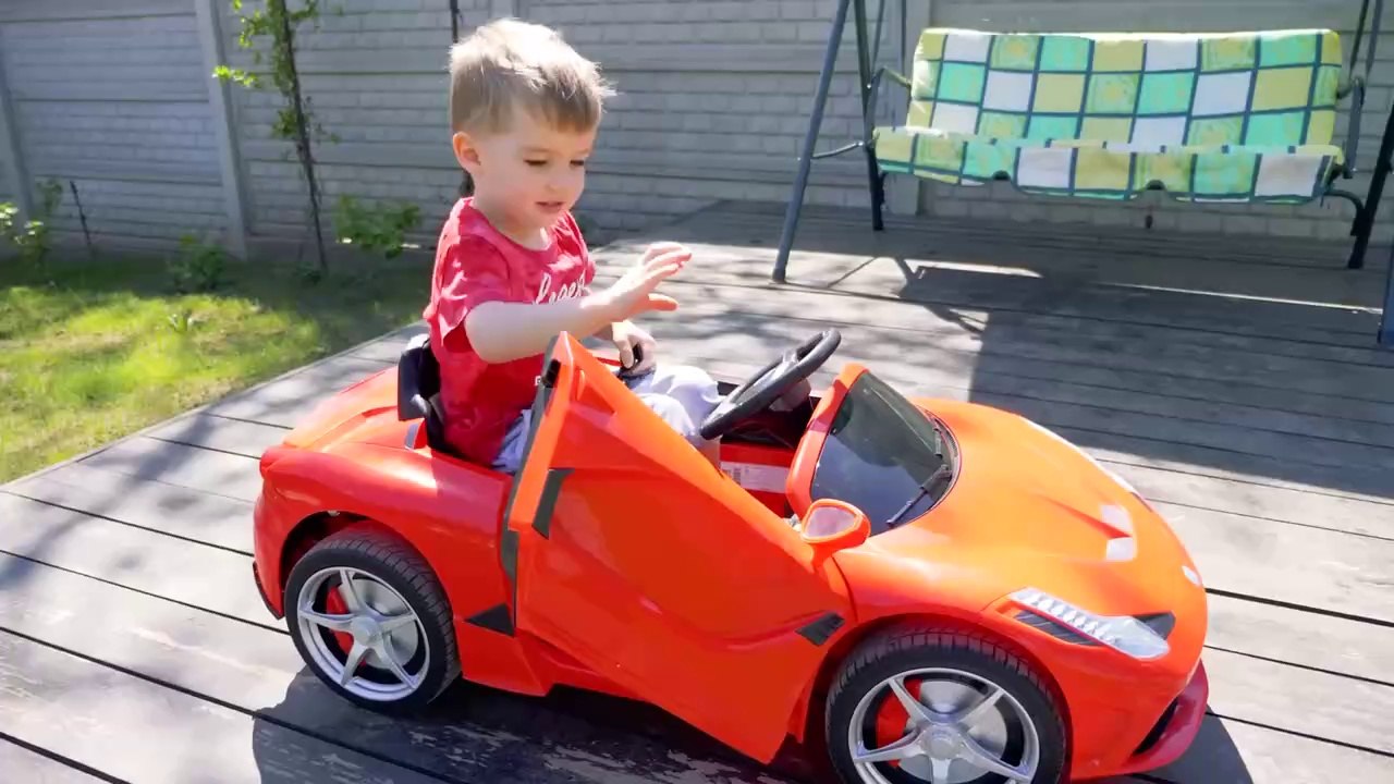 Arthur is playing at the car wash and washing his Ferrari