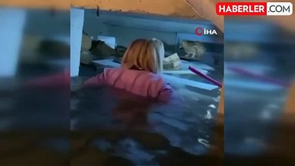 Selde mahsur kalan kediyi kurtaran kadın