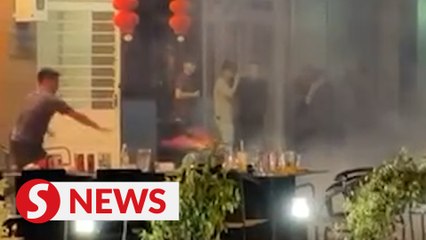 Burning firecrackers thrown at a lion dance troupe in Sandakan