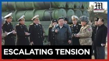 Kim oversees missile tests, warns of aggressive military stance