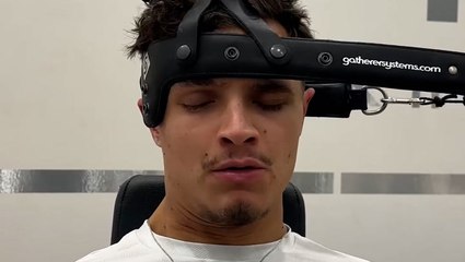 McLaren F1 driver Lando Norris shows off neck strengthening exercise