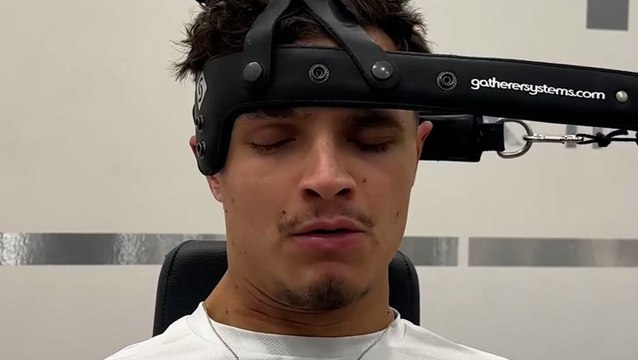 McLaren F1 driver Lando Norris shows off neck strengthening exercise