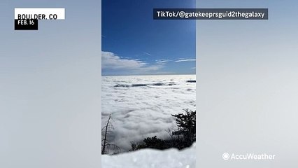Thick clouds flow like water over Colorado