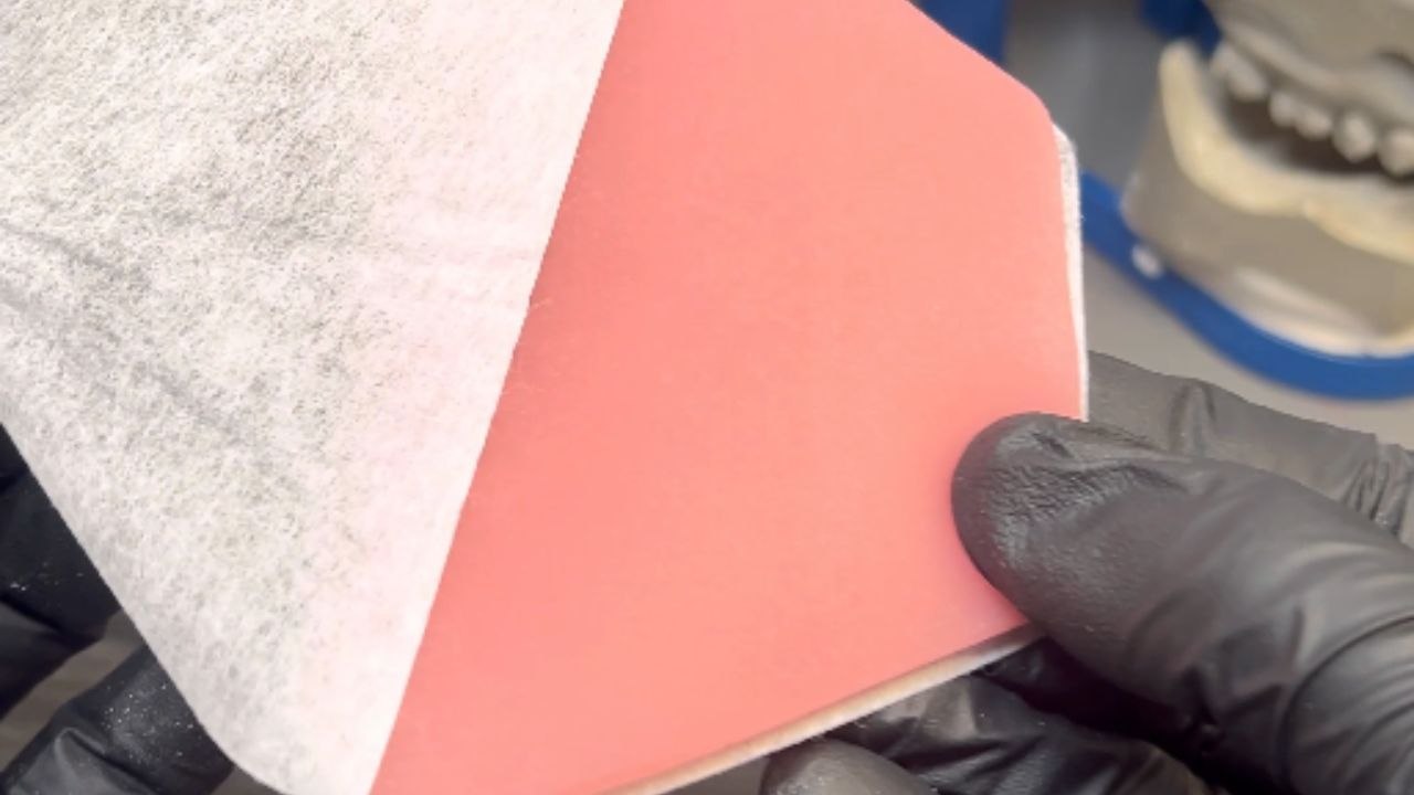 Dentist reconstructs a lower jaw, gums, and teeth model for patient