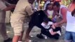 Woman drops her baby, as she gets a monkey off her head