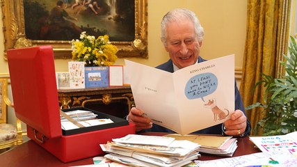 Watch King Charles laughing as he opens cards from public