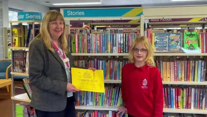 Julia Moxey receiving her Gold Secret Book Quest certificate from Crediton Library Supervisor Sue Lee video Alan Quick IMG_6083