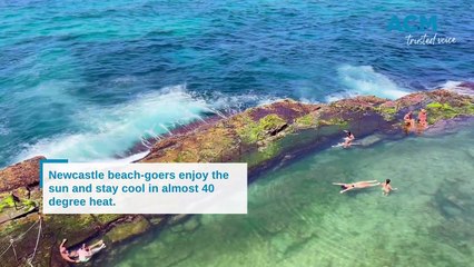 Beach-goers try to beat the heat in Newcastle.