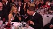 Roman Kemp and Kylie Minogue drink out of shoes together at Brit Awards 2024