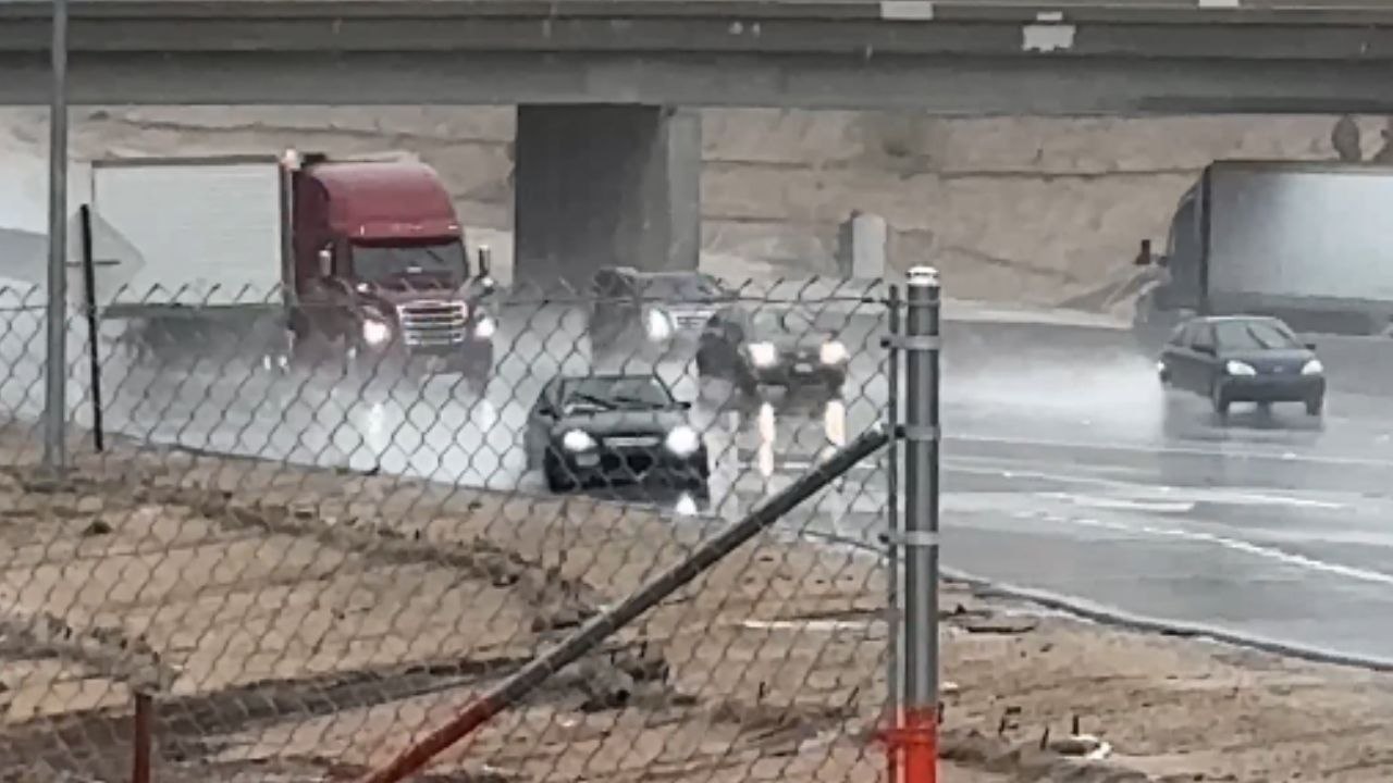 Driver does a perfect drift on rain-soaked road...