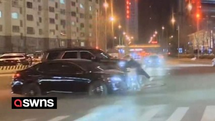 Motorcyclist leaps from his bike as it is crushed by a car