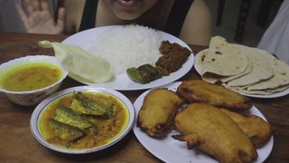 EATING DAL, FISH IN TOMATO GRAVY, BAIGAN PAKODE, CHAPATI, WHITE RICE, PAPPAD FRY, BAIGAN FRY, FISH MASALA