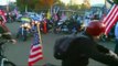 Hundreds ride with boy to show support for his U.S.-flag-decorated bike after school banned it