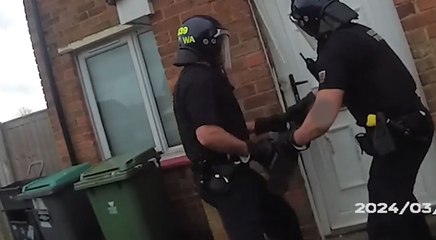 Police break down door in drugs raid