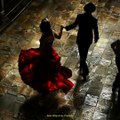 a spanish dance floor. a woman in a spanish red dress beckons a sly man to come dance the tango. the,Midjourney prompts