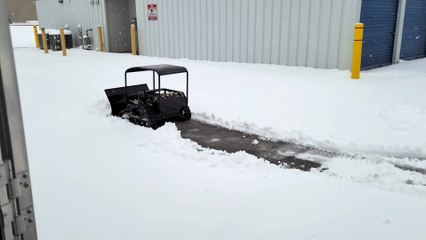 Snowplow pushing heavy wet snow left to right view