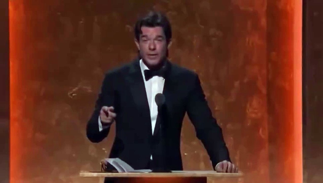 Robert Downey Jr. and Chris Nolan bursting out laughing at John Mulaney's joke about Marvel.