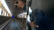Watch: NYPD officers jump onto subway tracks to rescue man as train approaches