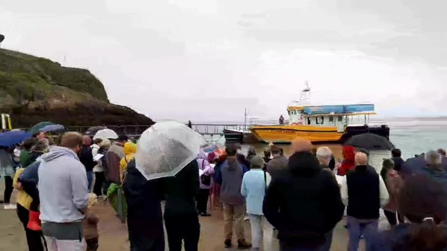 Baptisms in the rain on Castle Beach, Tenby