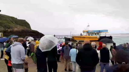 Baptisms in the rain on Castle Beach, Tenby