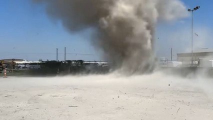 Dust devil engulfs man filming in intense video