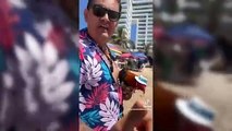 Este gallo con bermudas y sombrero en la playa será lo mejor que verás hoy