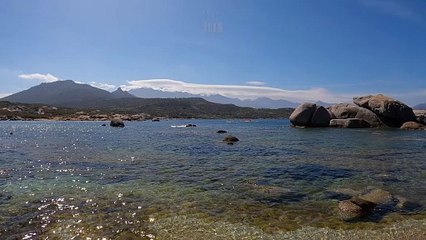 Sérénité et relaxation à la Punta di Spanu en Corse : mer, rochers et montagnes sous les nuages