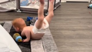 Strong-minded baby with Hypotonia does his best mermaid impression