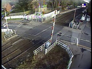 Van ploughs through level crossing